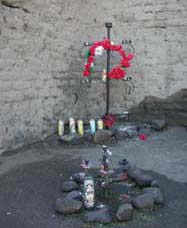 Detail of candles lit at El Tiradito shrine, Tucson