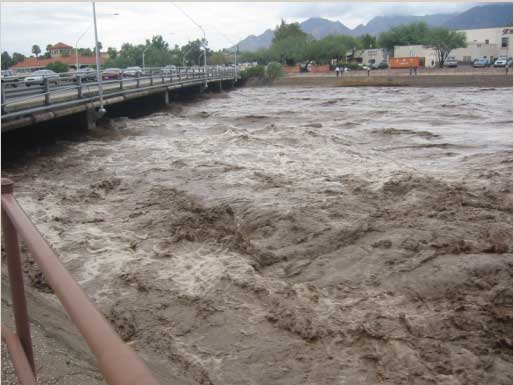 The Rillito 'River' of Tucson in flood stage, with water almost up to the bottom of the Campbell Avenue Bridge.