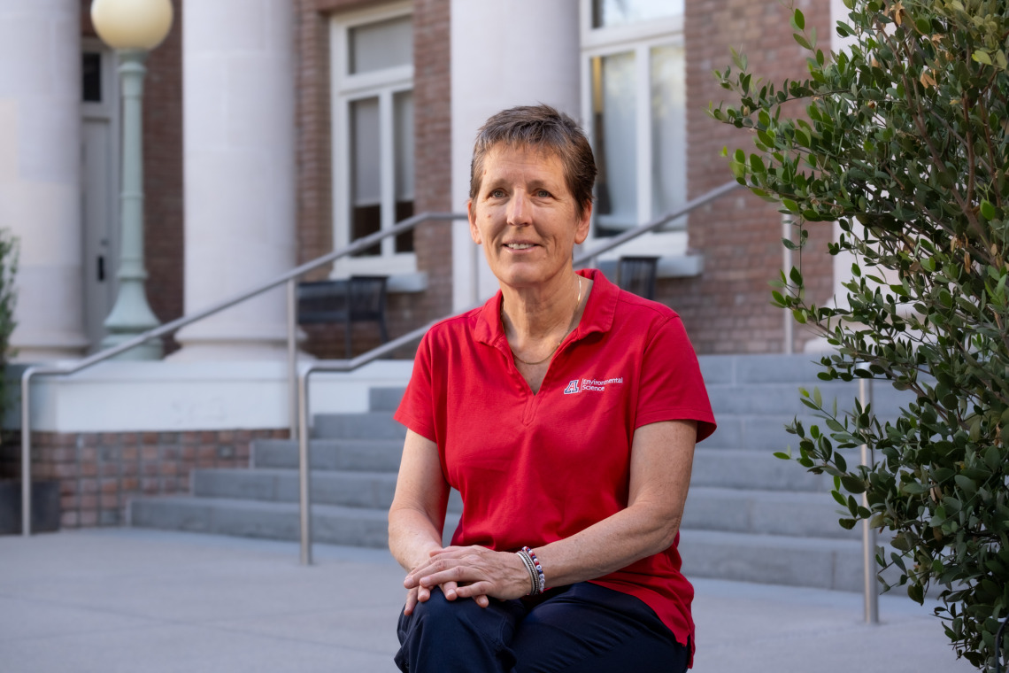 Joan Curry poses on the steps of Forbes Building on the UArizona main campus.