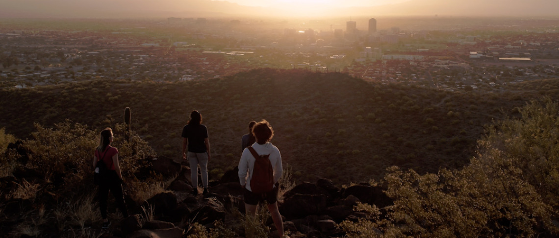 Students watch the sunset of Tucson