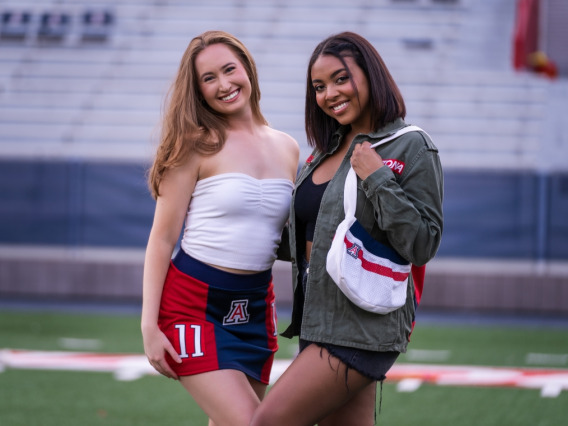 University of Arizona undergraduate students Erika Gay (right) and Jade Butcher model clothing and accessories from the Arizona Replay clothing line, which incorporates retired UArizona football jerseys and thrifted clothing.