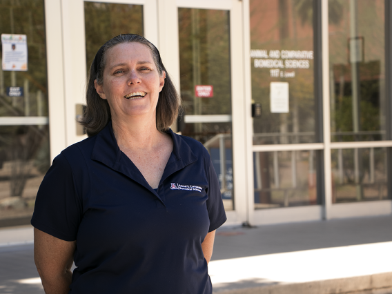 Fiona McCarthy poses in front of the School of Animal & Comparative Biomedical Sciences on the UA's main campus.